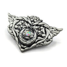 3d Heart shaped pin with wings and gemstones there's a floral texture