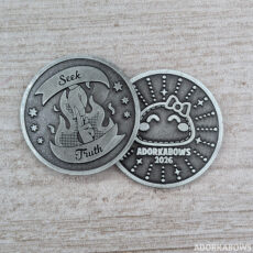 silver colored coin with the words Seek Truth and a hand holding an ofuda on fire. the back of the coin says AdorkaBows