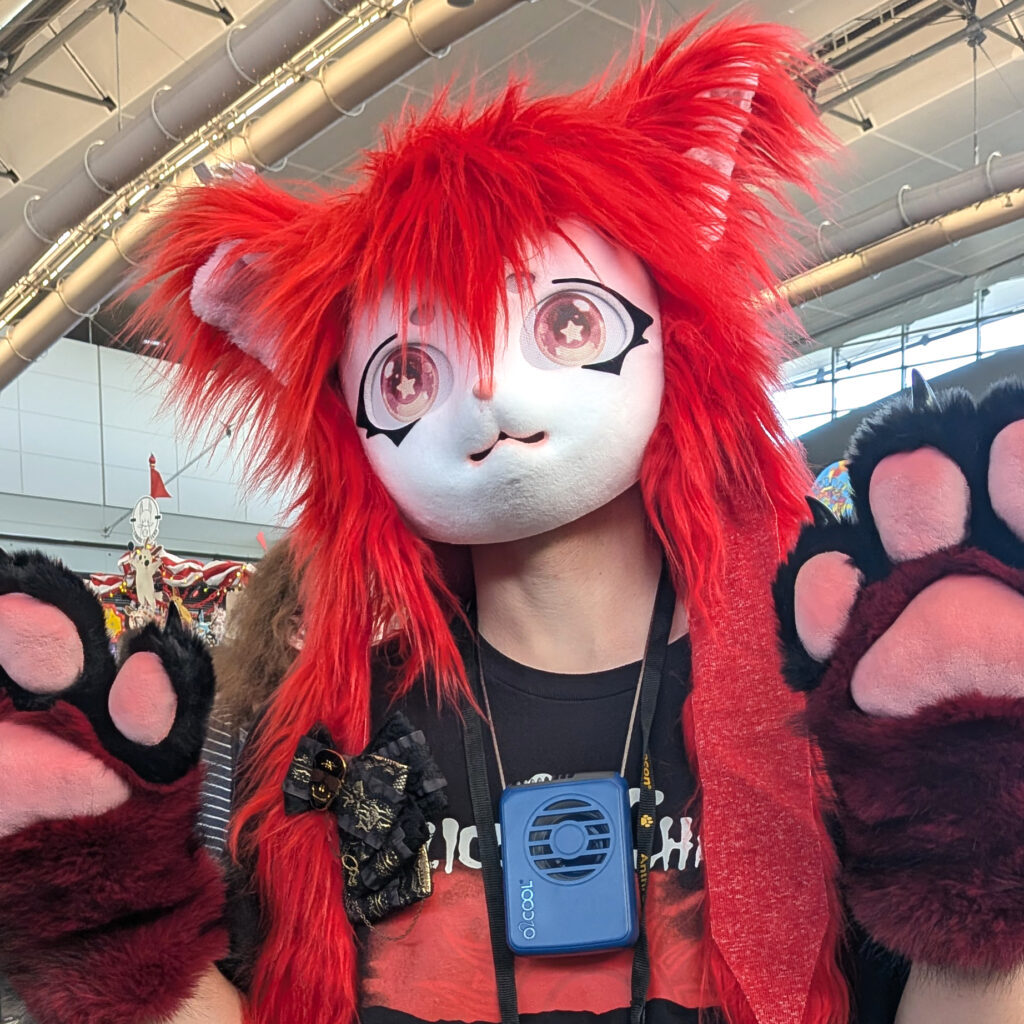 a fursuiter wearing one of my hair bows on their hanging hair