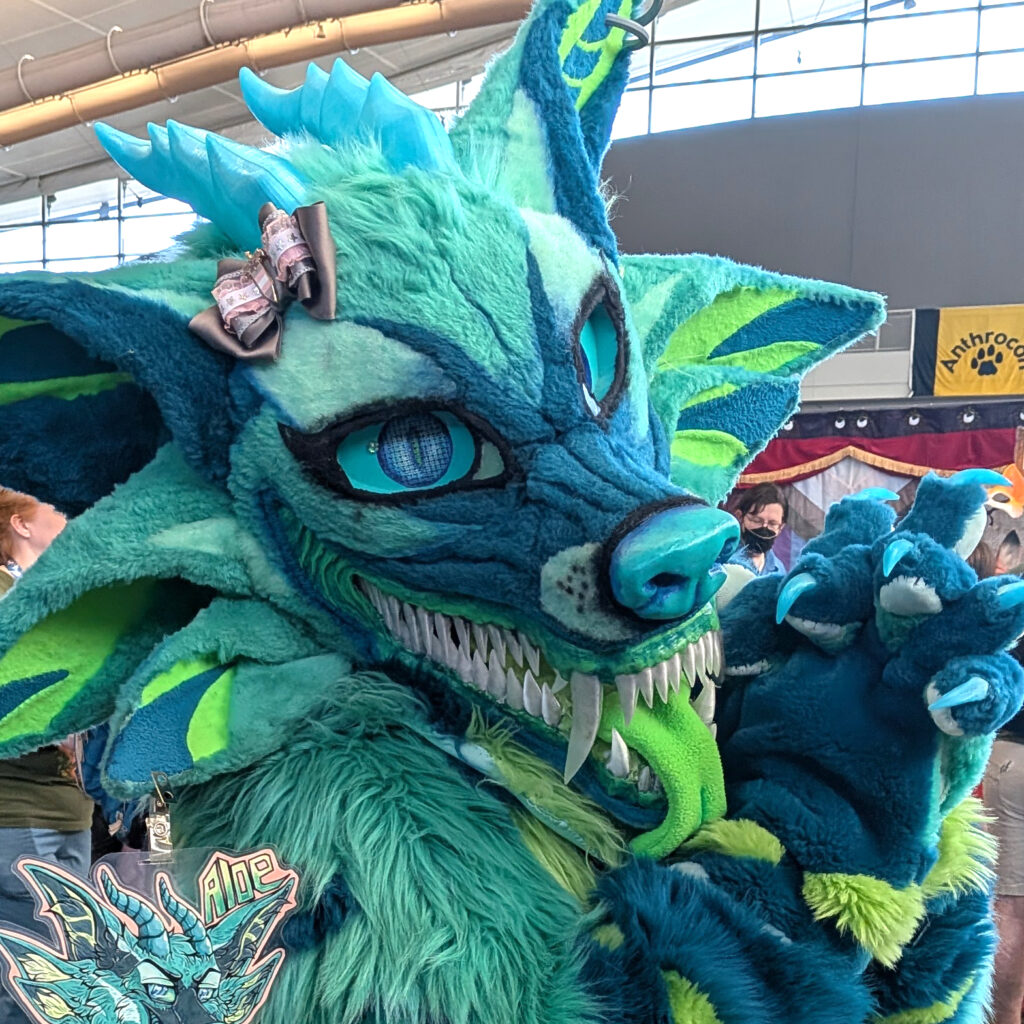 a dragon suiter wearing one of my hair bows on their head